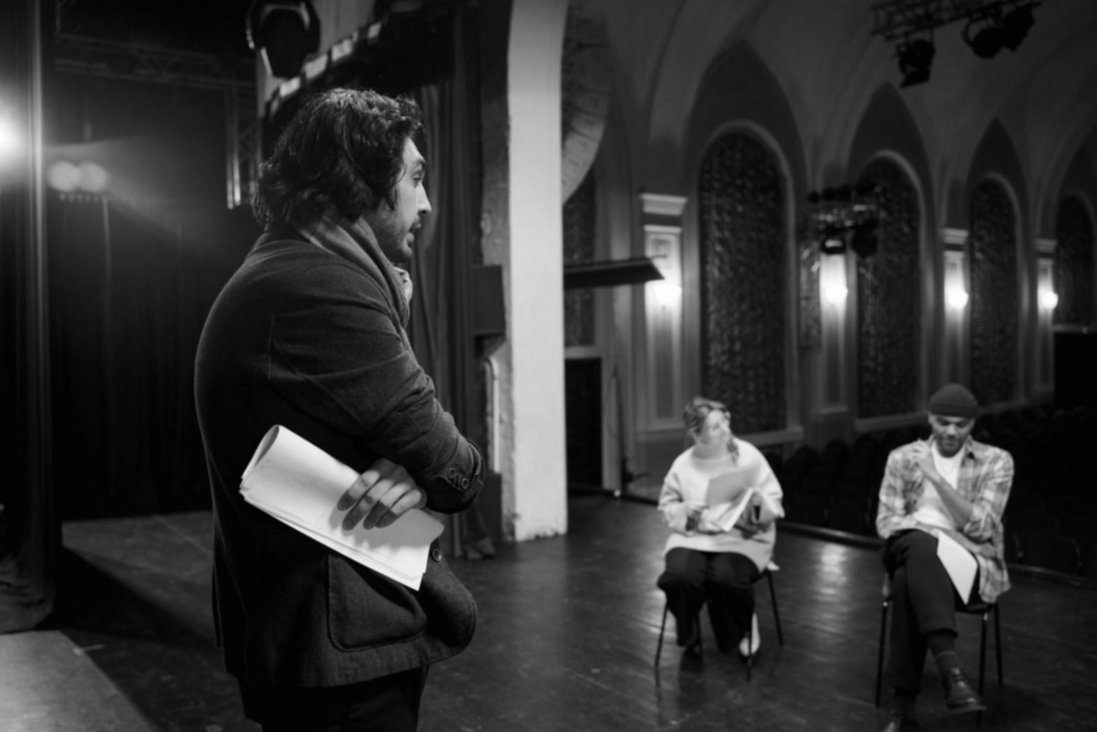 Comedy acting instructor demonstrating expressive techniques in a training session